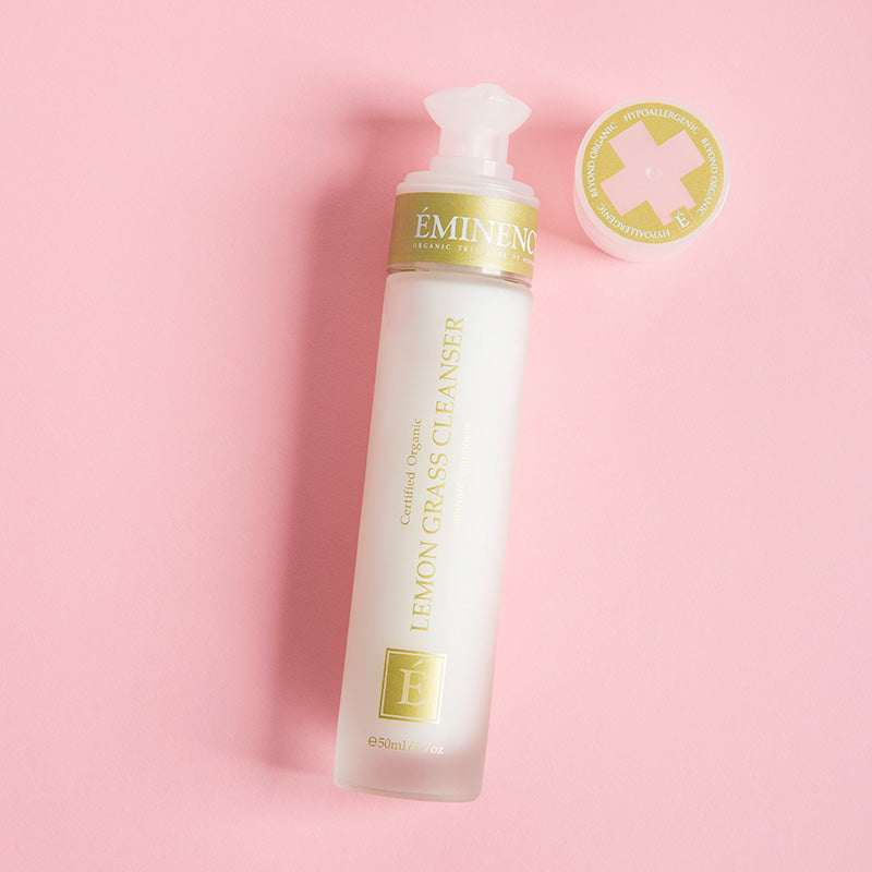 Eminence Lemon Grass Cleanser bottle on a pink background